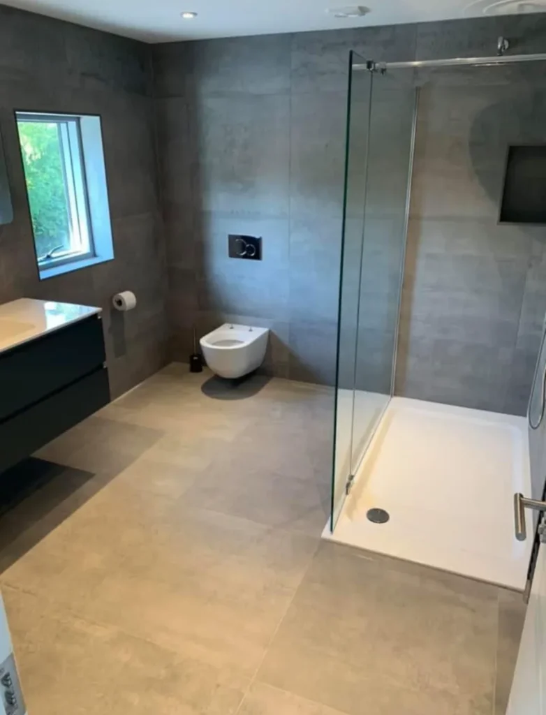 Large format porcelain bathroom tiles with walk-in shower and modern bathroom design installed by Stamford tiler.