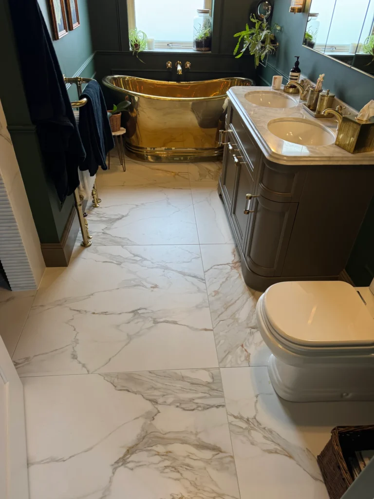 Large format marble effect bathroom floor tiles installed by Stamford tiler covering Stamford, Oakham and Uppingham.