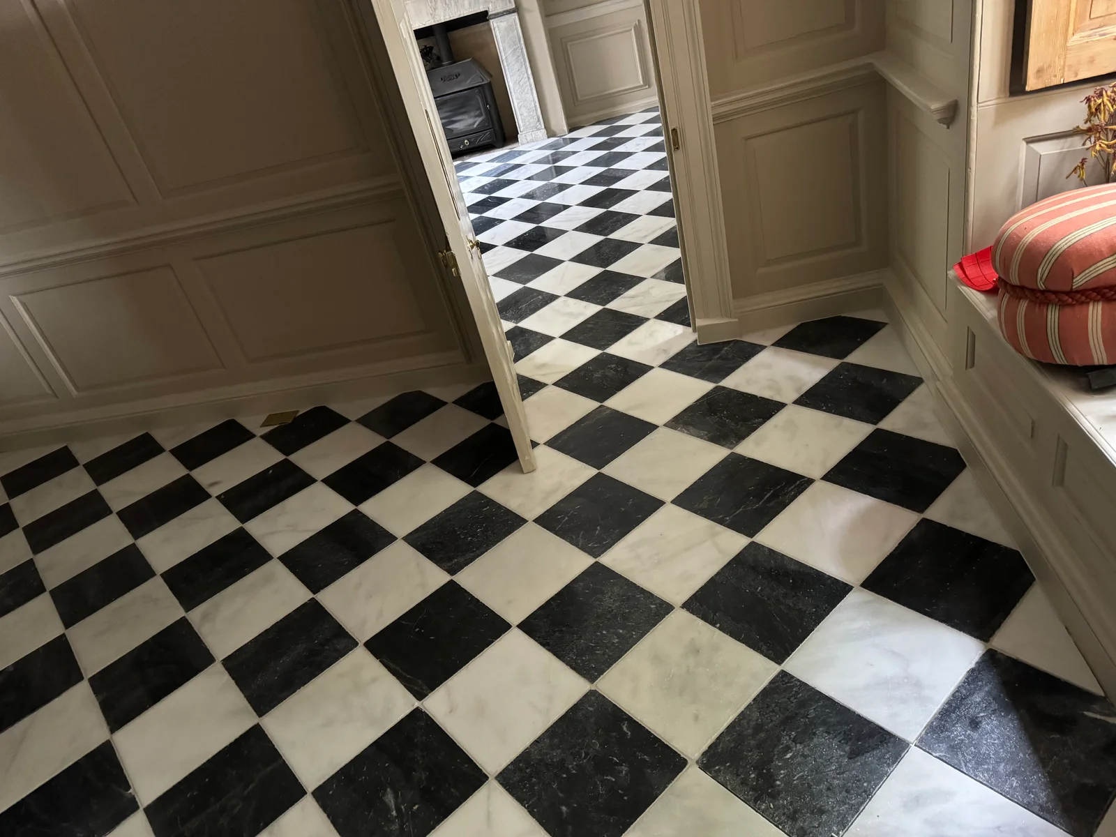 Black and white checkered hallway floor tiles installed by Stamford tiler covering Stamford, Oakham and Uppingham.